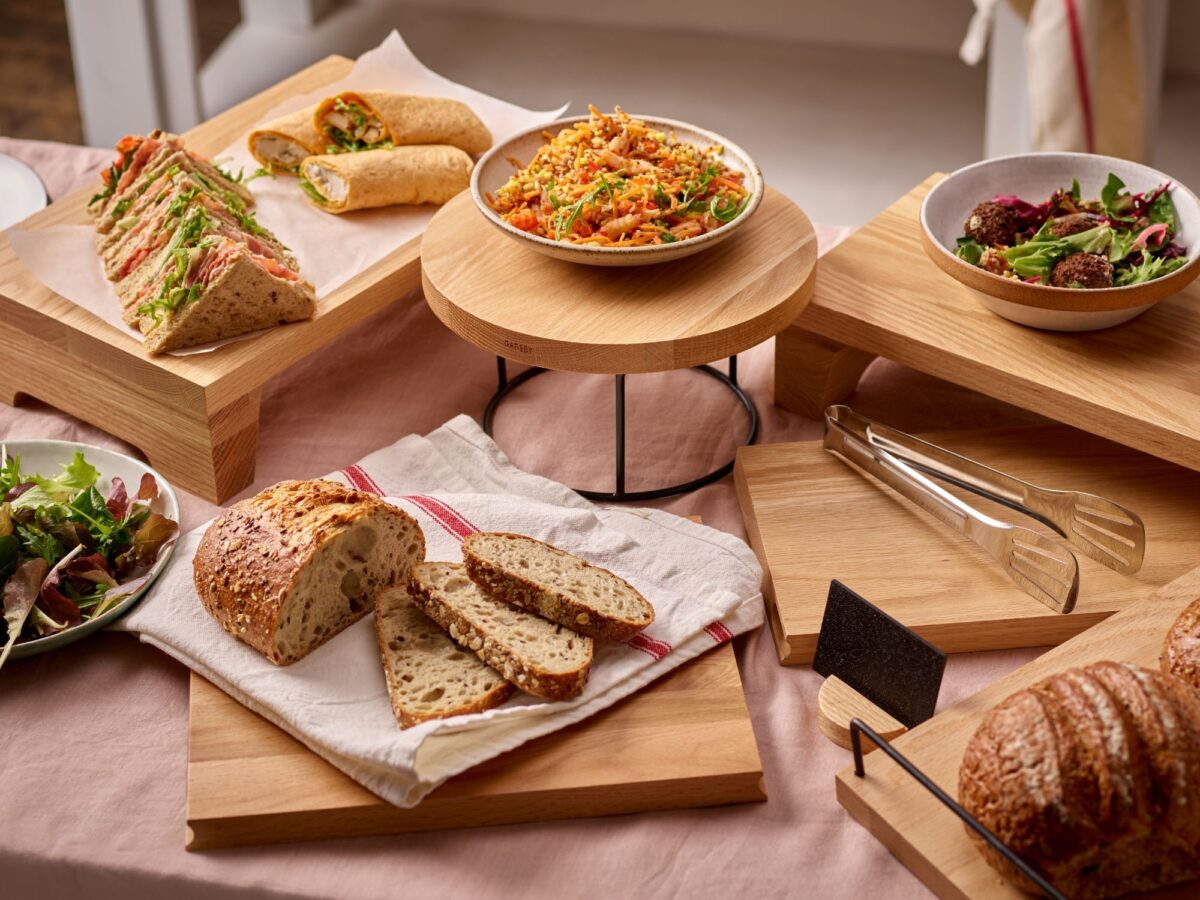 Selection of wooden displays and risers in a catering setting displaying food in a buffet style