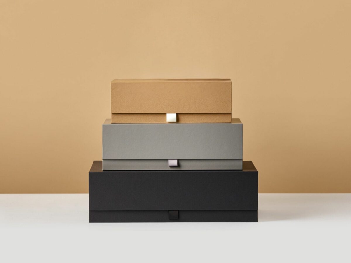 Tower of kraft, grey and black gift boxes and jar box