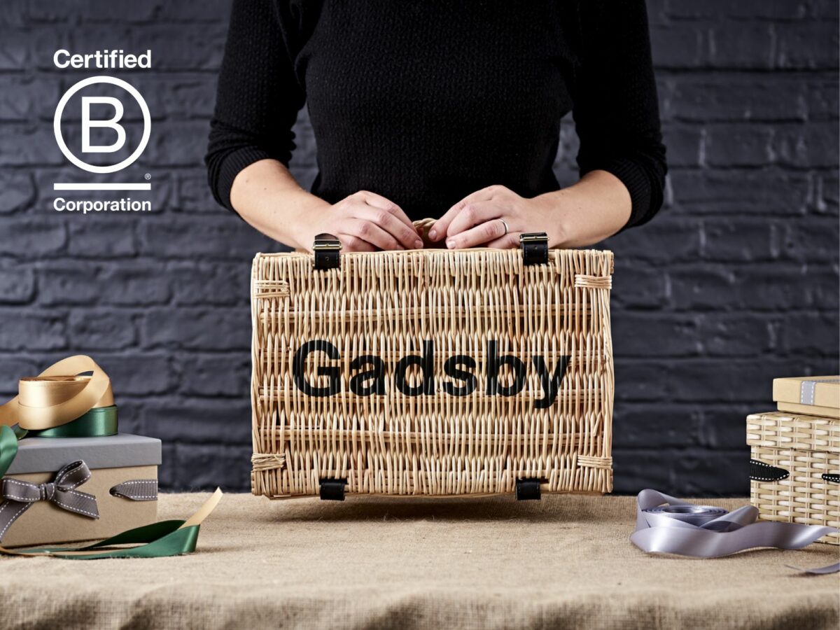 Person holding a wicker basket with Gadsby stencilled on the lid