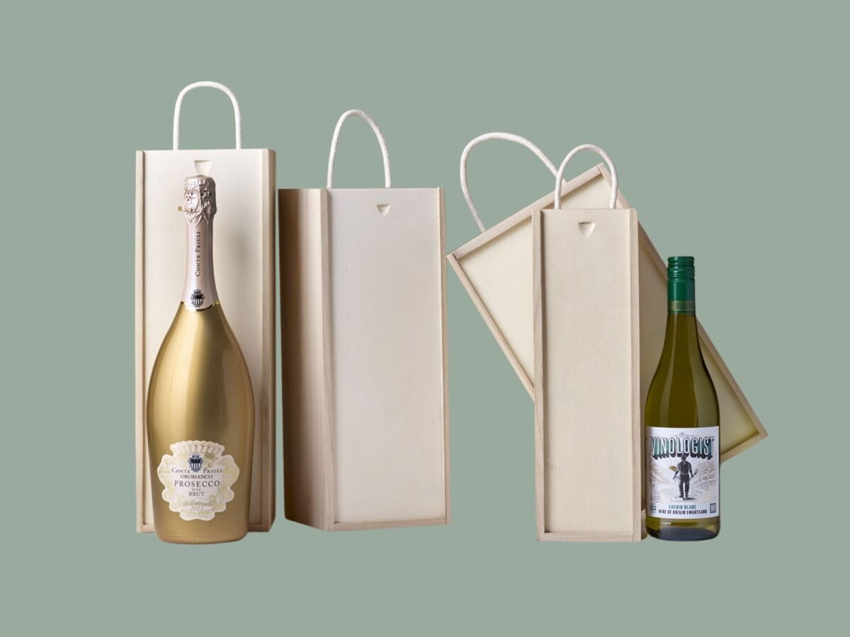 Selection of wooden bottle boxes on a sage green background