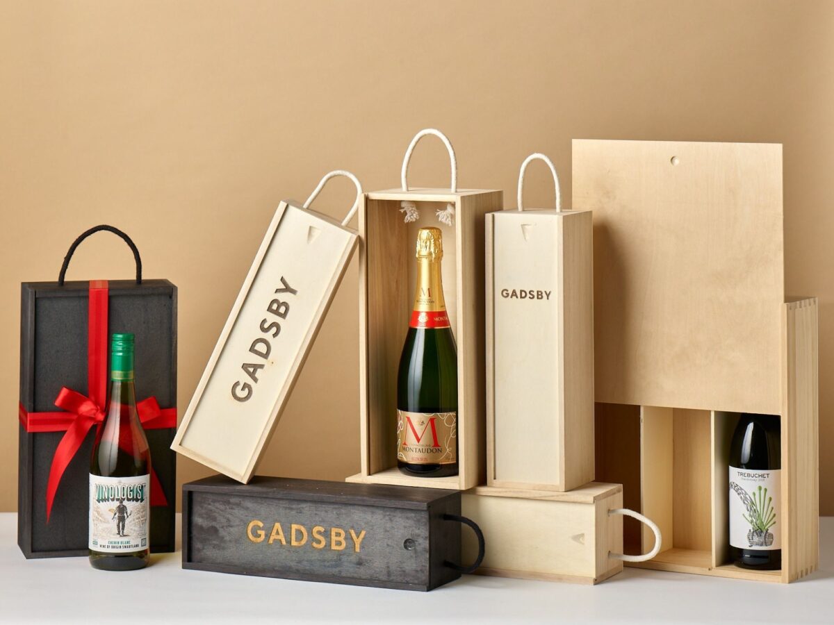 Selection of natural and stained black wooden bottle boxes in a variety of sizes.