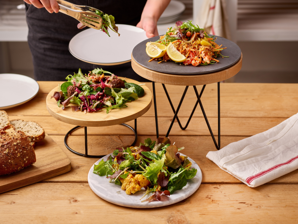 A trio of buffet display stands in a catering setting