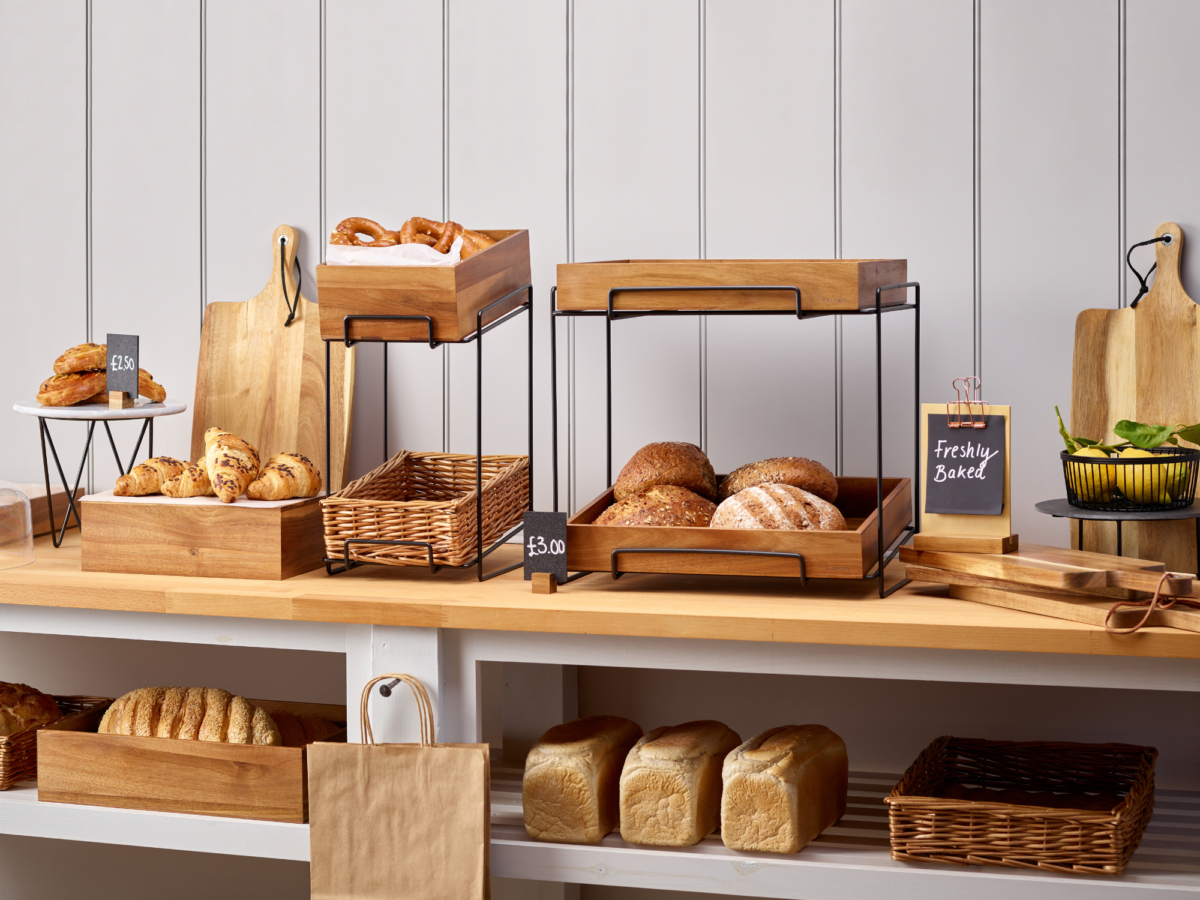 A range of crates and display baskets on a metal display stand sat on a counter top