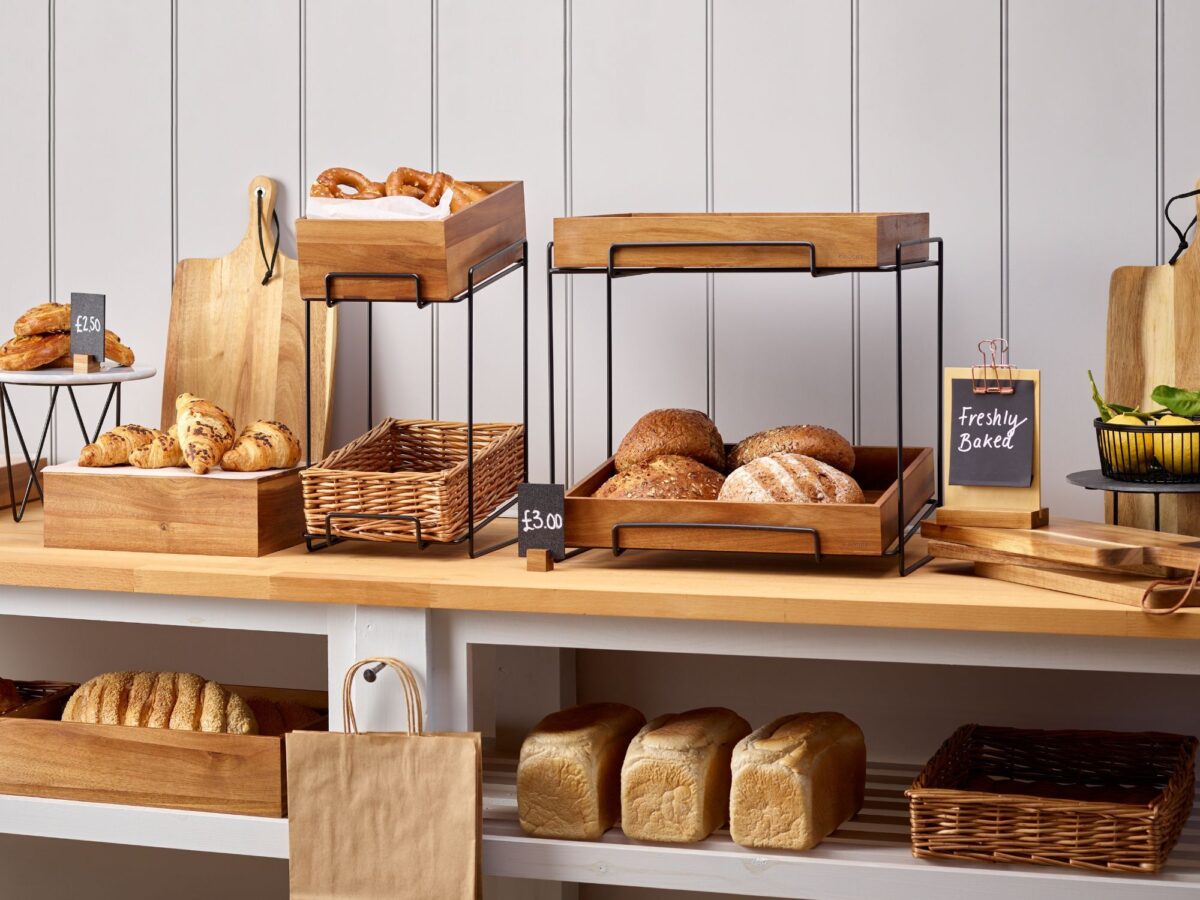 Range of counter top displays using metal risers and wooden crates filled with bakery items