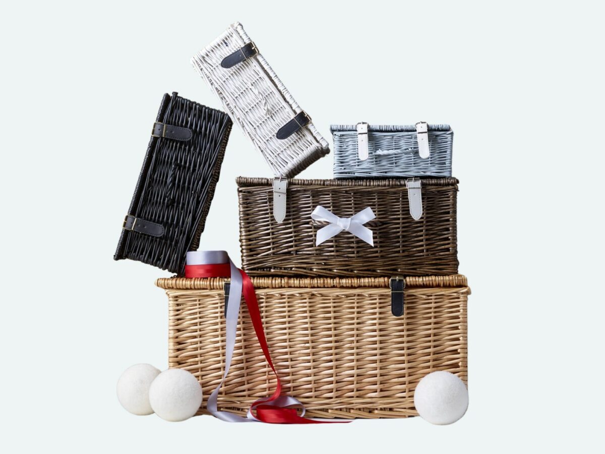 Range of wicker hamper baskets in a variety of colours and sizes stacked up for corporate gifting