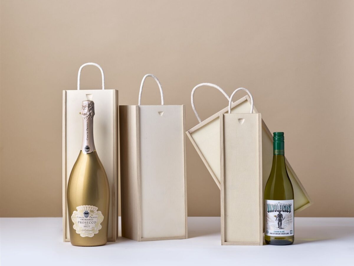 Selection of wooden wine bottle boxes with a bottle of wine and bottle of prosecco