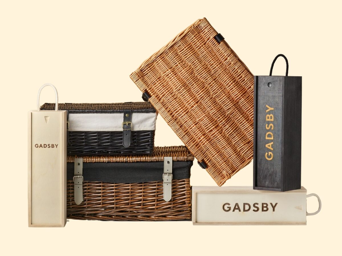 A stack of hampers including wicker hamper baskets and wooden wine boxes