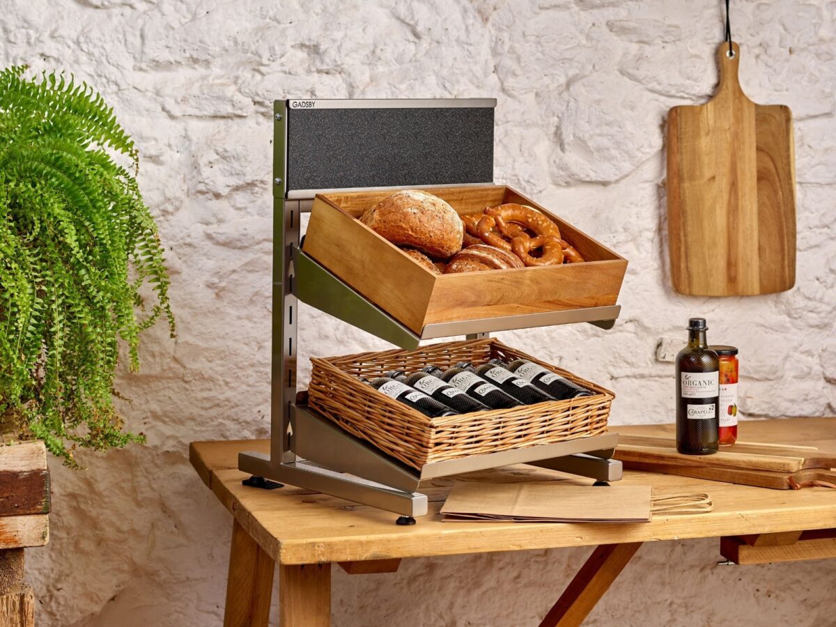 Selection of pastries, breads and other bakery items on wooden trays and risers