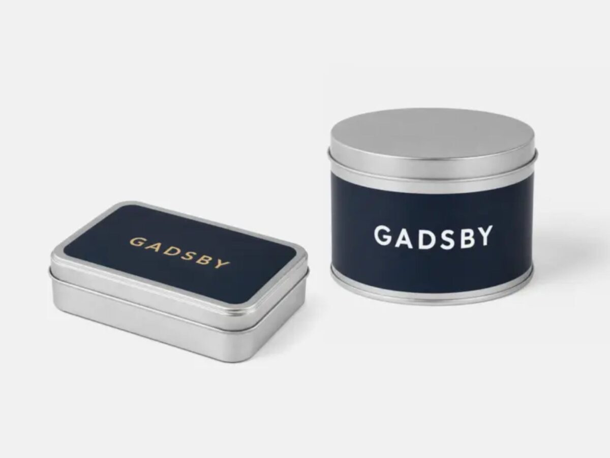 Two tins showing Gadsby branding with a navy blue sticker