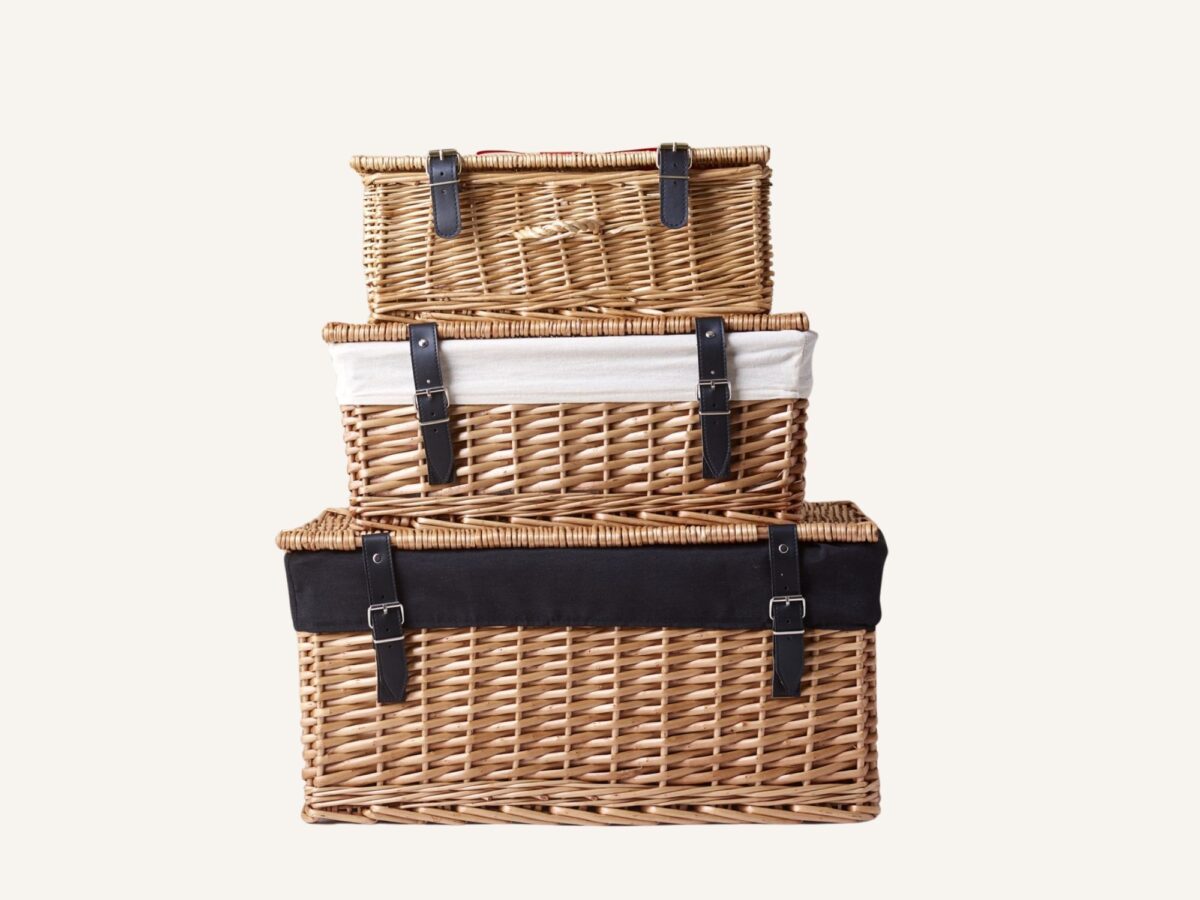 Three empty wicker hamper baskets each stacked one on top of each other with liners and without liners