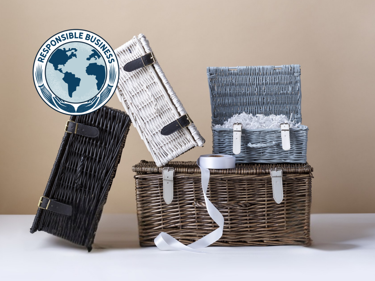 Selection of wicker hamper baskets in white, black, light grey and bronze with responsible business logo in the top left corner