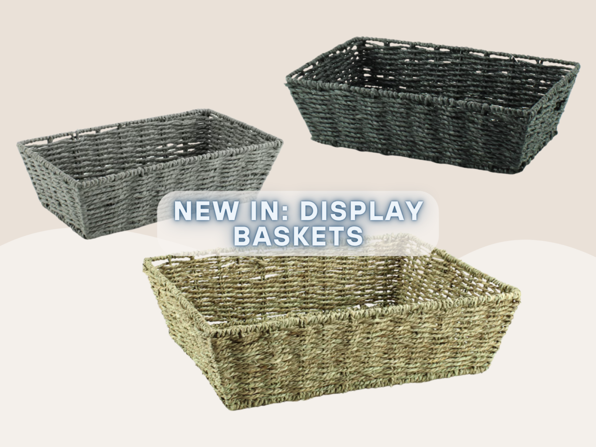 Three display baskets on a plain background, one is made from natural seagrass and the other two are made from paper rope in black and grey