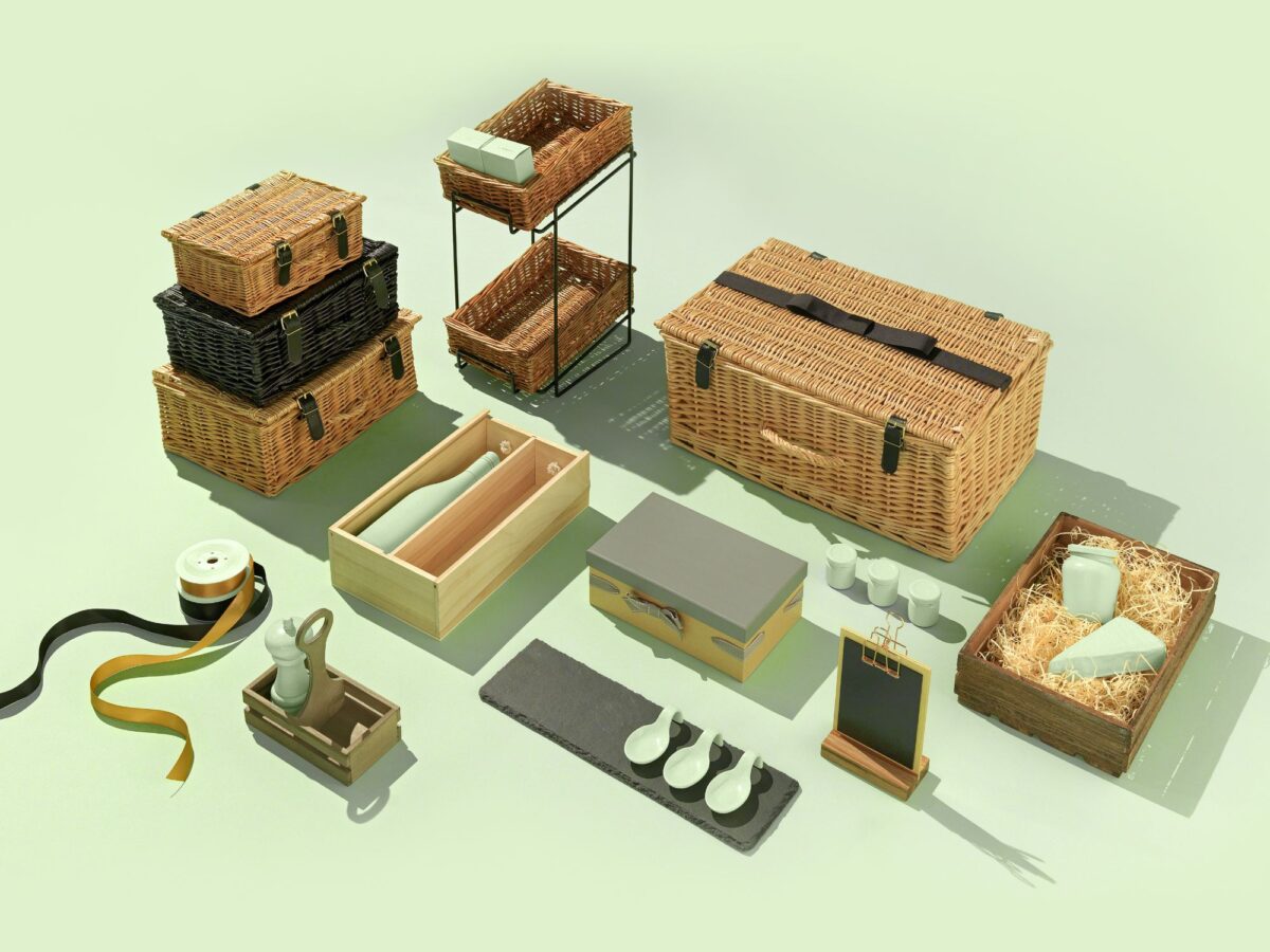 Wooden hampers and wicker hampers arranged on a green background