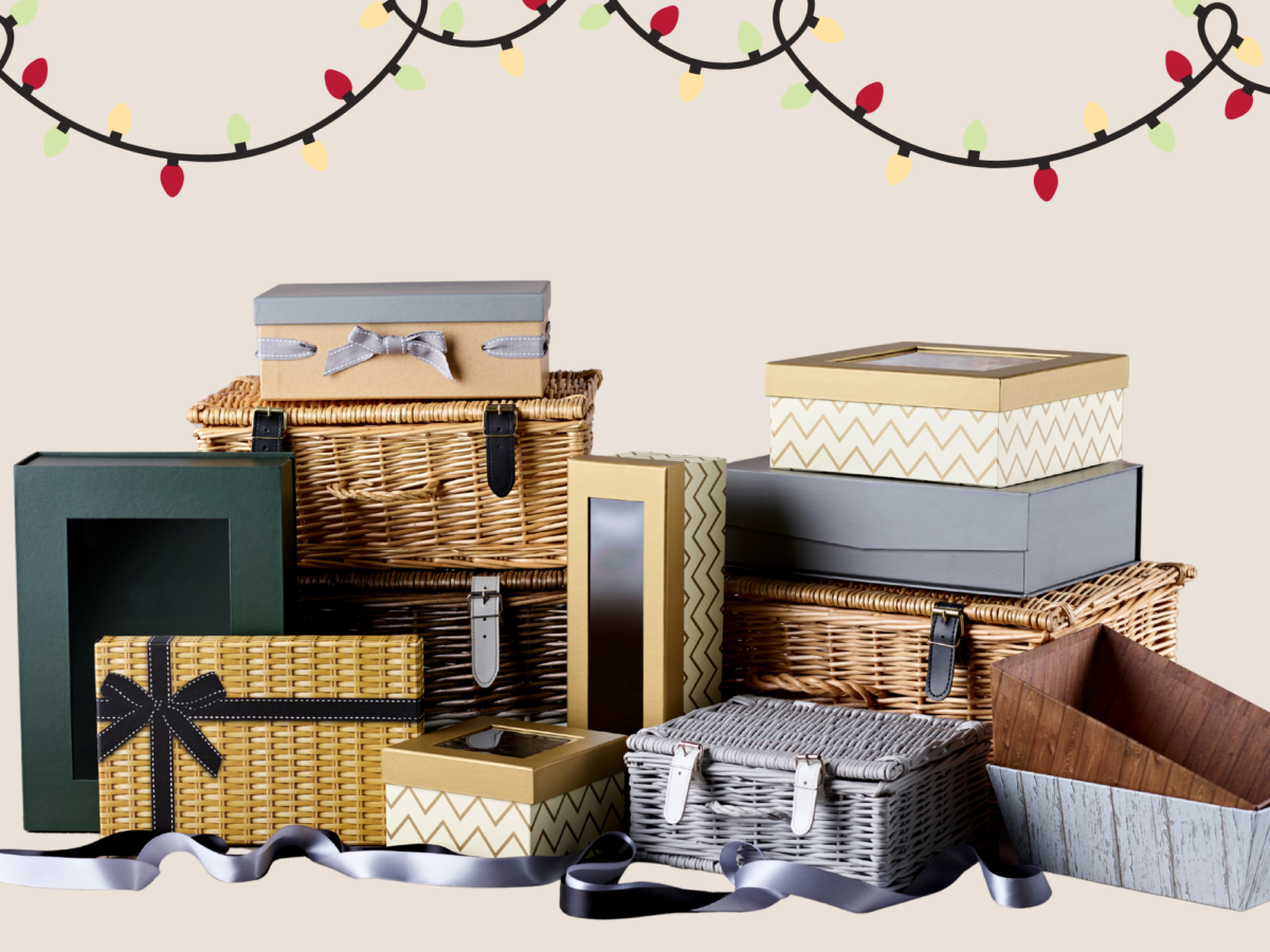 Retail display prep for Christmas which includes a variety of hamper baskets, cardboard boxes and more displayed on a cream background