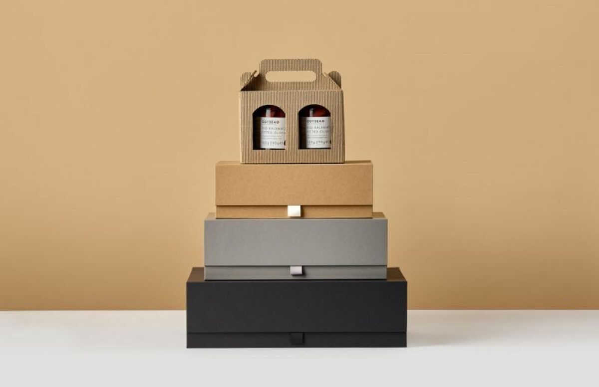 Stack of different coloured card hamper boxes with a jar box on the top