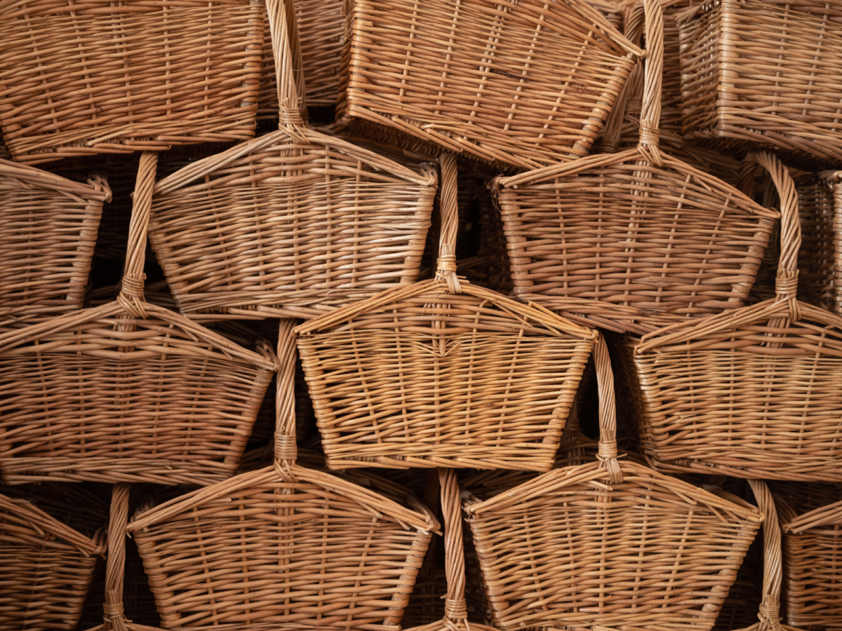 A stack of small wicker huntsman baskets all piled up on top of each other