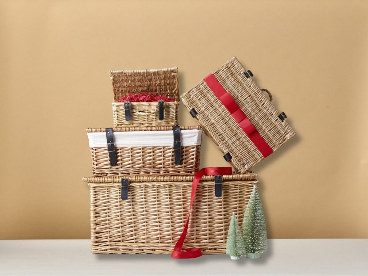 Stack of natural wicker hamper baskets wrapped with red ribbon